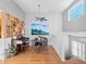 Bright dining area featuring a piano, shelving unit, and a modern ceiling fan at 9993 E Mexico Ave, Aurora, CO 80247