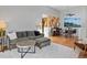 Living room view with hardwood floors, a comfortable seating area, and an adjacent dining space at 9993 E Mexico Ave, Aurora, CO 80247