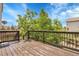 Wooden deck with railing surrounded by greenery and trees at 8935 Sleepy Grass Ct, Parker, CO 80134