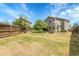 Large backyard with grass, fence and the back of the house at 8935 Sleepy Grass Ct, Parker, CO 80134