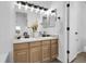 Bathroom featuring a double sink vanity with warm wood cabinetry at 8935 Sleepy Grass Ct, Parker, CO 80134