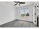 Bright bedroom with ceiling fan and large window view at 8935 Sleepy Grass Ct, Parker, CO 80134