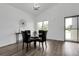 Contemporary dining area with a glass table, black chairs, and modern decor at 8935 Sleepy Grass Ct, Parker, CO 80134