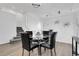 Modern dining room with stylish chairs and a glass table, steps leading to upper floors at 8935 Sleepy Grass Ct, Parker, CO 80134