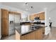 Bright kitchen with stainless steel appliances, black countertops, and a central island at 8935 Sleepy Grass Ct, Parker, CO 80134