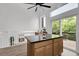 Open kitchen featuring a large island, vaulted ceiling, and natural light from the sliding glass door at 8935 Sleepy Grass Ct, Parker, CO 80134