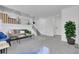 Bright living room featuring a gray couch and gray carpet at 8935 Sleepy Grass Ct, Parker, CO 80134