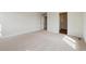 Bedroom with neutral carpet, white walls, and an open doorway at 5718 Ranch St, Mead, CO 80504