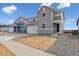 Charming two-story home with gray siding and a well-manicured yard at 5718 Ranch St, Mead, CO 80504