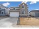 Charming two-story home featuring a two-car garage and neutral gray siding at 5718 Ranch St, Mead, CO 80504