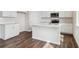 Stylish kitchen with white cabinets, island with countertop, and stainless steel appliances at 5718 Ranch St, Mead, CO 80504