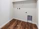 Laundry room area with modern hookups and wood-look flooring at 5718 Ranch St, Mead, CO 80504
