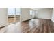 Bright living room with sliding glass doors to the backyard, featuring hardwood floors at 5718 Ranch St, Mead, CO 80504
