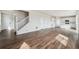 Open-concept living room with hardwood floors and a staircase at 5718 Ranch St, Mead, CO 80504