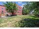 Expansive backyard featuring a large grassy area and mature trees, perfect for relaxation at 85 N Grant St # 28, Denver, CO 80203