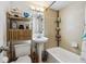 Well-lit bathroom featuring a pedestal sink, storage shelves, and a shower-tub combo at 85 N Grant St # 28, Denver, CO 80203