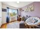 Bright bedroom with large window, hardwood floors, purple accent wall, and ample natural light at 85 N Grant St # 28, Denver, CO 80203