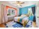 Inviting bedroom featuring colorful bedding, a ceiling fan, and large windows that offer lots of light at 85 N Grant St # 28, Denver, CO 80203