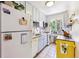 Efficient kitchen featuring white cabinets, butcher block counters, stainless appliances, and a bright window at 85 N Grant St # 28, Denver, CO 80203