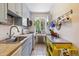 Charming kitchen with light blue cabinets, butcher block countertops, and a stainless steel sink by a bright window at 85 N Grant St # 28, Denver, CO 80203