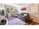 Bright living room featuring hardwood floors, a comfortable sofa, and large windows with views of greenery at 85 N Grant St # 28, Denver, CO 80203