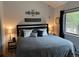 Comfortable bedroom with a modern, neutral color palette, lamps, and a window with views at 9705 Canon Dr, Sedalia, CO 80135
