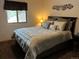 Neutral bedroom design featuring a decorative headboard, accent pillows, and a view to the outdoors at 9705 Canon Dr, Sedalia, CO 80135