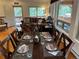 Formal dining table set for six, adjacent to the living room with outdoor views at 9705 Canon Dr, Sedalia, CO 80135