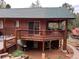 Exterior view of a wood-sided home with a deck, patio, and basement access at 9705 Canon Dr, Sedalia, CO 80135