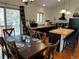 Eat in kitchen featuring black appliances, island with bar seating, and dining table with place settings at 9705 Canon Dr, Sedalia, CO 80135