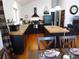 Bright eat in kitchen featuring black appliances, wood floors, and island with tile countertop at 9705 Canon Dr, Sedalia, CO 80135