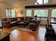 Comfortable living room with a leather sofa, a large window, and hardwood floors at 9705 Canon Dr, Sedalia, CO 80135