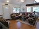 Cozy living room featuring hardwood floors, a sectional sofa, and natural light at 9705 Canon Dr, Sedalia, CO 80135