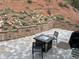 View of a patio with a fire pit, grill, outdoor seating, and terraced landscaping at 9705 Canon Dr, Sedalia, CO 80135