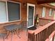 Cozy front porch with wooden bear, outdoor seating, and wood stained siding at 9705 Canon Dr, Sedalia, CO 80135