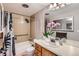 Cozy bathroom with standard tub shower, neutral colored tile, and wood vanity at 1850 Folsom St # 402, Boulder, CO 80302