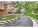 A private driveway leading to the building's entrance, with lush landscaping and mature trees at 1850 Folsom St # 402, Boulder, CO 80302