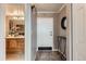 Inviting hallway with gray walls that leads to a bathroom, with a tiled floor and an entryway at 1850 Folsom St # 402, Boulder, CO 80302