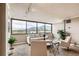 Bright living room with large windows offering stunning mountain views and neutral, cozy furnishings at 1850 Folsom St # 402, Boulder, CO 80302