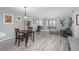 Open-concept living room with modern flooring, a dining table, and a view to the outside balcony at 800 N Pearl St # 707, Denver, CO 80203