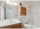 Tiled bathroom featuring vanity, mirror, toilet, and shower-tub combo at 2453 S Xanadu Way # C, Aurora, CO 80014