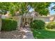 Landscaped townhomes with lawn, plantings, and sidewalk entry at 2453 S Xanadu Way # C, Aurora, CO 80014
