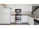 Modern kitchen featuring stainless steel appliances, granite countertops, and white cabinets at 2453 S Xanadu Way # C, Aurora, CO 80014