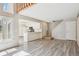 Open-concept living area featuring new flooring and an abundance of natural light at 2453 S Xanadu Way # C, Aurora, CO 80014