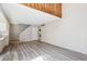Open living area featuring new flooring, staircase, and laundry closet at 2453 S Xanadu Way # C, Aurora, CO 80014