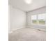 Neutral carpeted bedroom with a double window providing natural light and a view of the outside scenery at 2611 Prairie Flax St, Berthoud, CO 80513