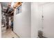 Clean basement featuring concrete walls, a water heater, and exposed pipes at 2022 S Helena St # G, Aurora, CO 80013