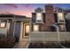 Charming townhome featuring a unique brick chimney and a welcoming white picket fence at 2022 S Helena St # G, Aurora, CO 80013