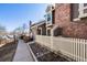 Side exterior view of a townhouse with a brick chimney and manicured landscaping at 2022 S Helena St # G, Aurora, CO 80013