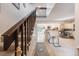 Hallway with staircase and tile floors leads to the kitchen and living areas at 2022 S Helena St # G, Aurora, CO 80013